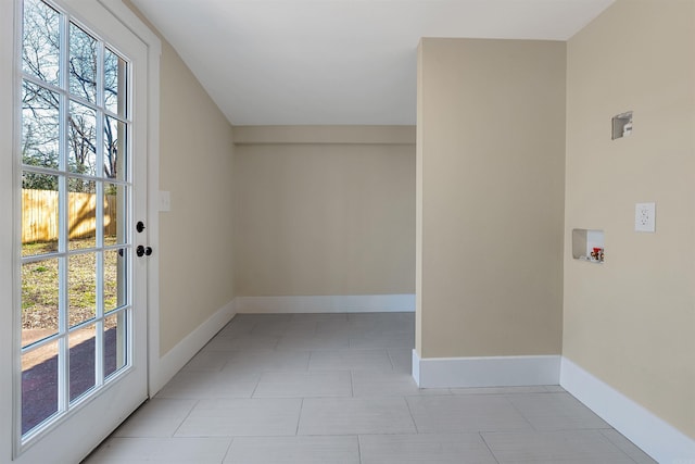 interior space with tile patterned floors and baseboards