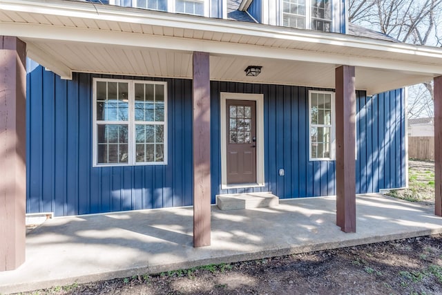 entrance to property featuring a porch and board and batten siding