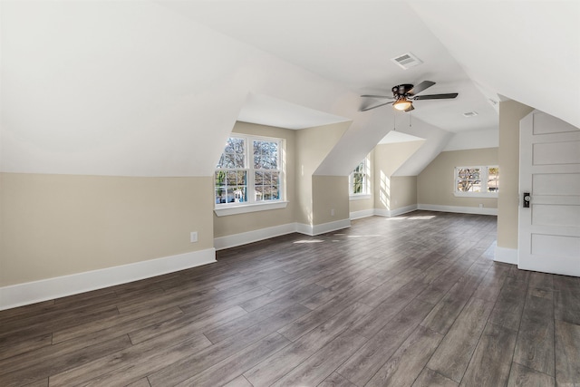 bonus room featuring plenty of natural light, baseboards, visible vents, and dark wood-style flooring