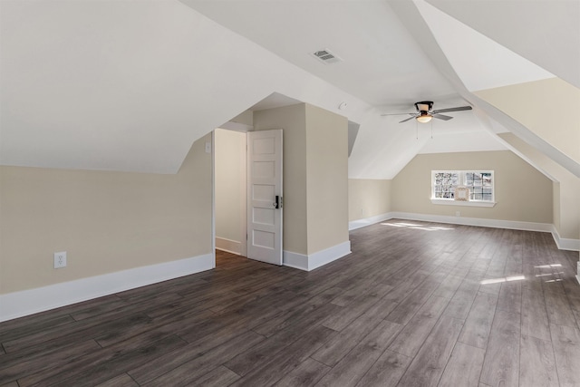 bonus room with visible vents, ceiling fan, dark wood-style flooring, and vaulted ceiling