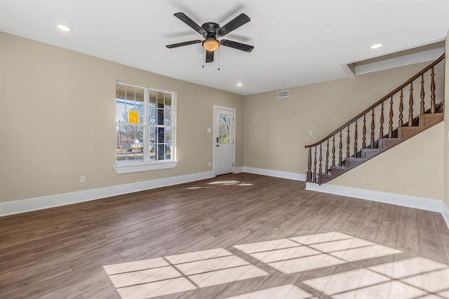 entrance foyer with stairs, baseboards, and wood finished floors