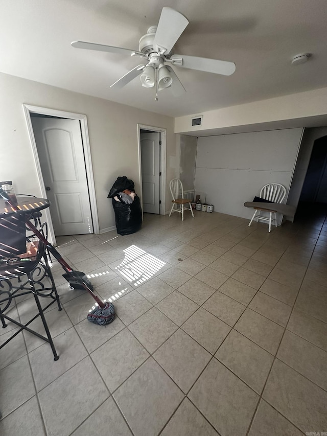 interior space with tile patterned flooring, visible vents, and ceiling fan