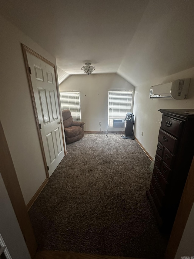 sitting room with a wall unit AC, baseboards, carpet, and vaulted ceiling