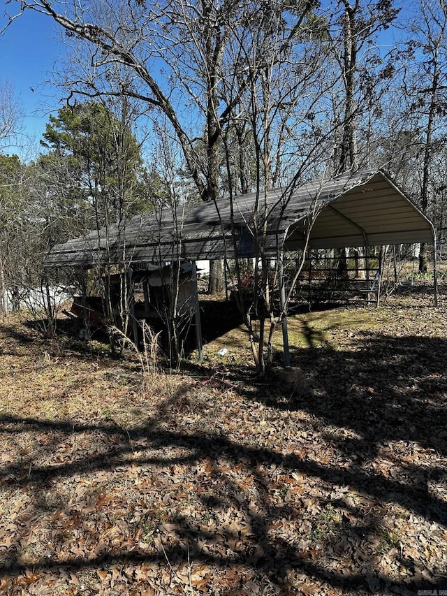 back of property featuring a detached carport