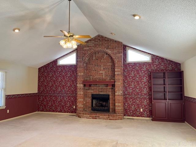 unfurnished living room featuring a wainscoted wall, light colored carpet, and wallpapered walls