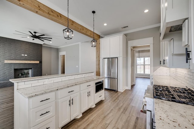 kitchen featuring high end fridge, tasteful backsplash, crown molding, built in microwave, and ceiling fan