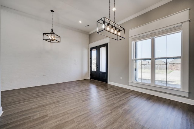 foyer entrance with baseboards, ornamental molding, french doors, a notable chandelier, and dark wood-style flooring