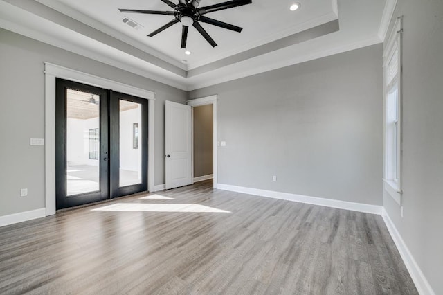 spare room featuring french doors, baseboards, visible vents, and wood finished floors