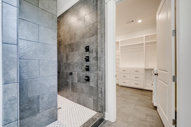 full bath featuring visible vents, a walk in closet, crown molding, and a walk in shower