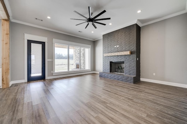 unfurnished living room with wood finished floors, baseboards, and ornamental molding