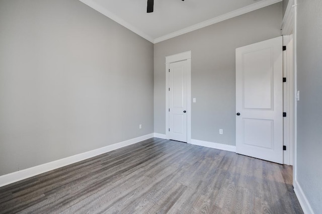 interior space featuring wood finished floors, crown molding, a ceiling fan, and baseboards