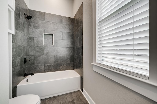 bathroom featuring tile patterned floors, shower / washtub combination, toilet, and baseboards