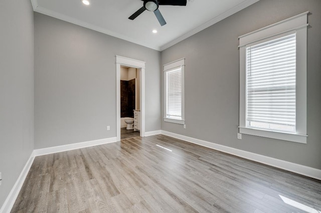 empty room featuring ornamental molding, a ceiling fan, wood finished floors, recessed lighting, and baseboards