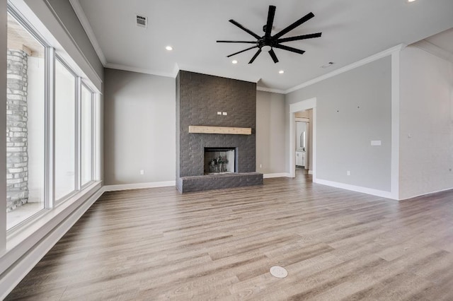 unfurnished living room featuring visible vents, baseboards, a ceiling fan, and wood finished floors