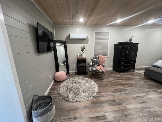 interior space featuring a wall unit AC, wood finished floors, baseboards, and wooden ceiling