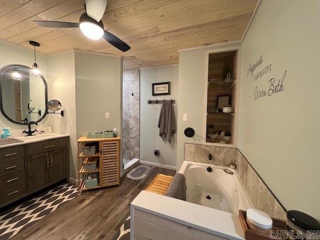 bathroom with wood finished floors, a tub with jets, wooden ceiling, ceiling fan, and vanity