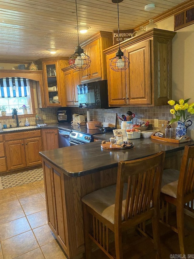 kitchen featuring a sink, backsplash, black appliances, and brown cabinetry