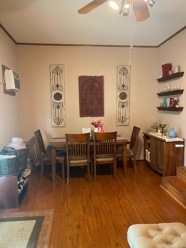 dining space featuring a wall mounted air conditioner, ornamental molding, light wood finished floors, and ceiling fan