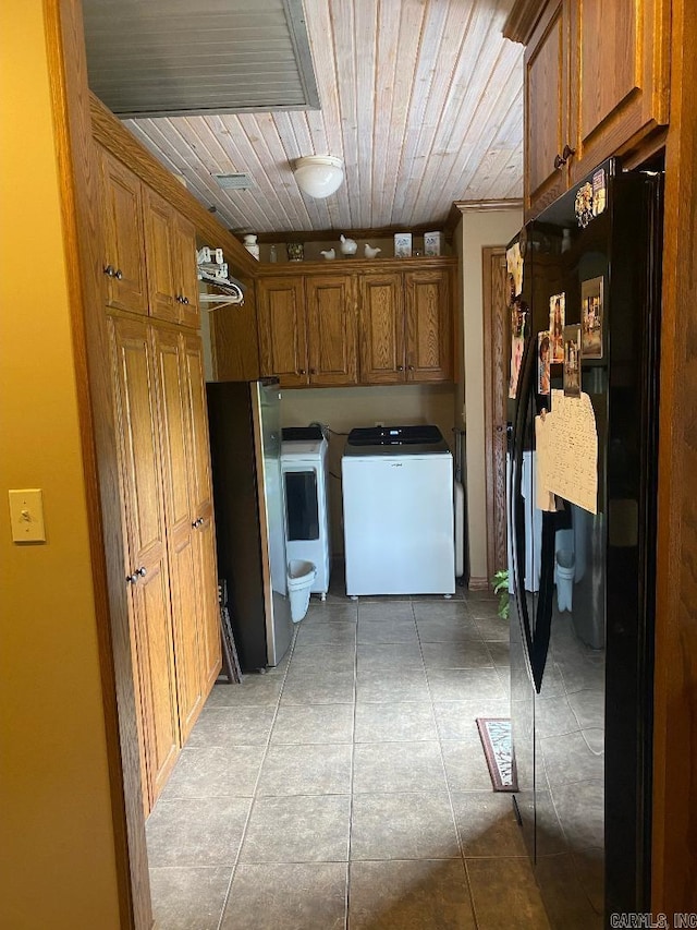 kitchen with separate washer and dryer, wooden ceiling, brown cabinetry, and freestanding refrigerator