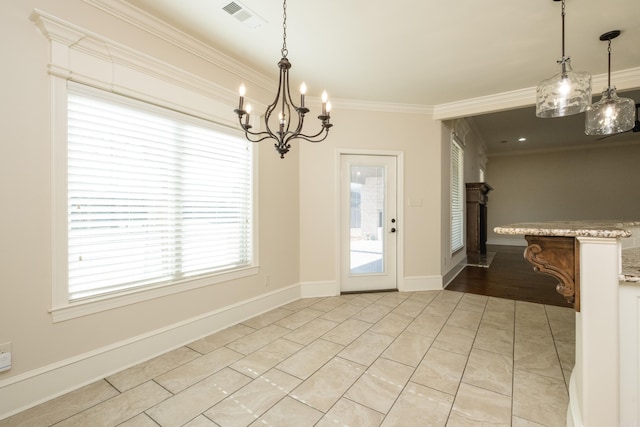 unfurnished dining area featuring visible vents, baseboards, a notable chandelier, and crown molding