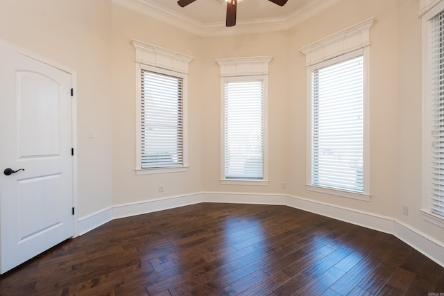 unfurnished room featuring baseboards, dark wood finished floors, a ceiling fan, and crown molding