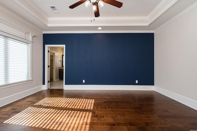 unfurnished room featuring visible vents, ceiling fan, a tray ceiling, and wood finished floors