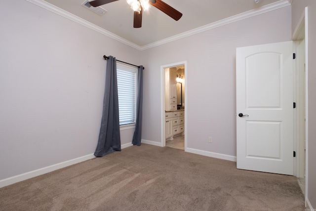 unfurnished bedroom with visible vents, connected bathroom, crown molding, baseboards, and light colored carpet