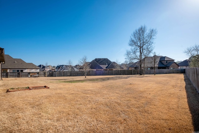 view of yard featuring a residential view and a fenced backyard