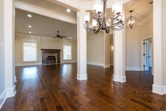 unfurnished living room with ceiling fan with notable chandelier, dark wood-style flooring, and ornamental molding