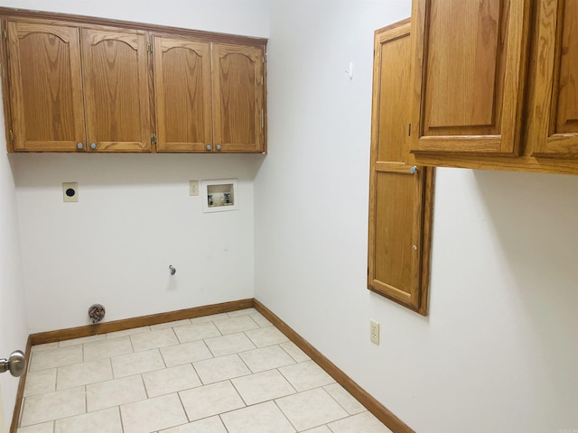 clothes washing area with hookup for a washing machine, cabinet space, baseboards, and hookup for an electric dryer