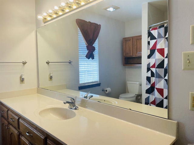 bathroom featuring curtained shower, toilet, and vanity