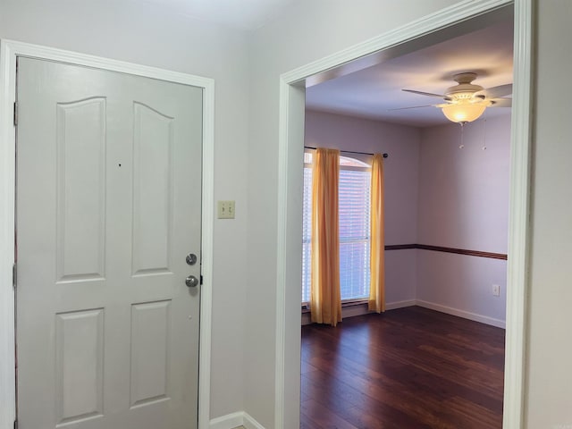 entrance foyer featuring baseboards, a ceiling fan, and dark wood-style flooring