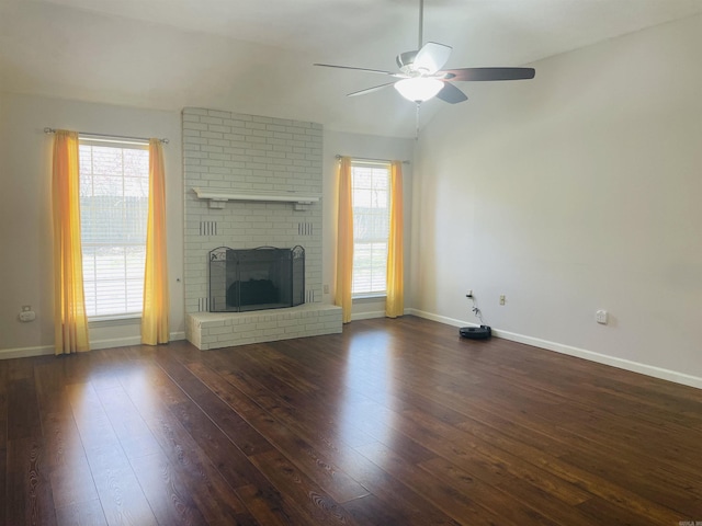 unfurnished living room with dark wood-style floors, baseboards, a fireplace, lofted ceiling, and ceiling fan