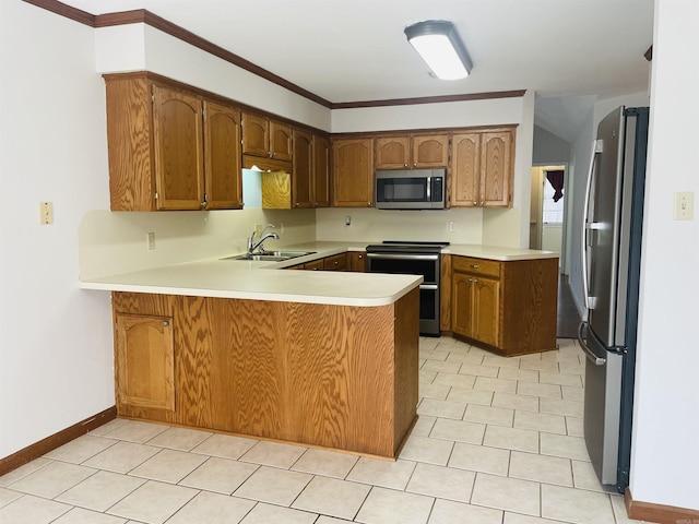 kitchen featuring baseboards, a peninsula, a sink, light countertops, and appliances with stainless steel finishes