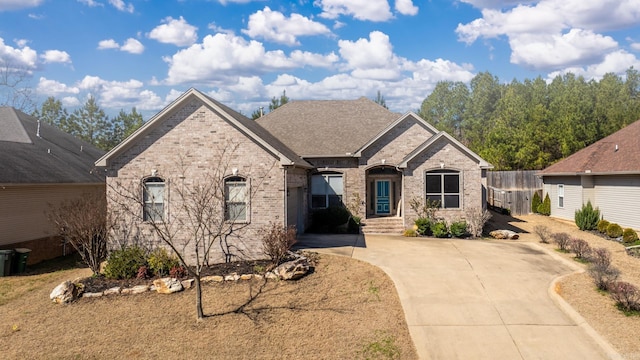 view of front of property featuring brick siding and driveway