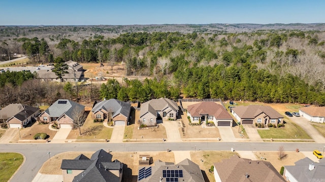 aerial view featuring a wooded view and a residential view