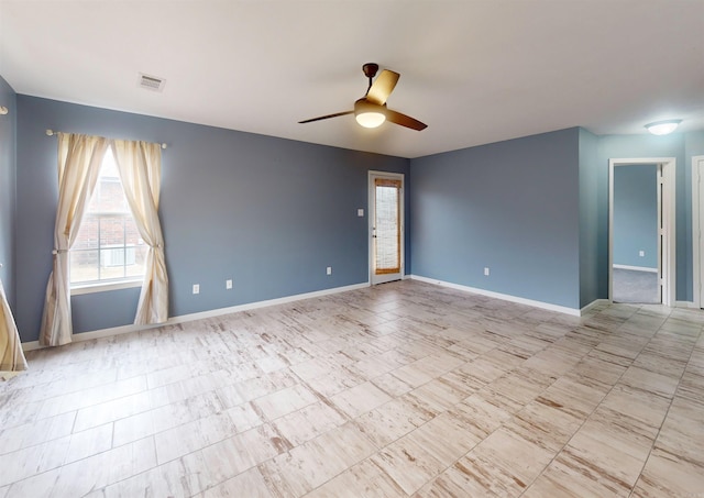 empty room with visible vents, baseboards, and ceiling fan