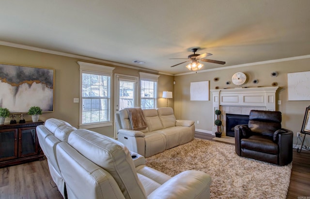 living room with crown molding and wood finished floors