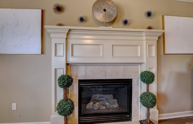 details with baseboards and a fireplace