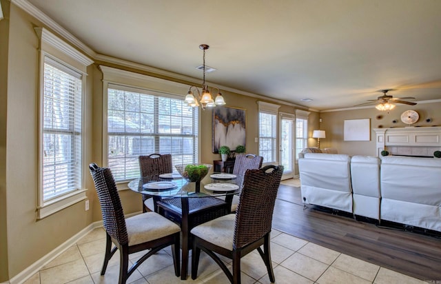 dining area featuring light tile patterned floors, visible vents, ceiling fan with notable chandelier, and crown molding