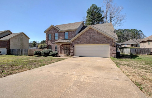 traditional home featuring brick siding, an attached garage, a front yard, and fence