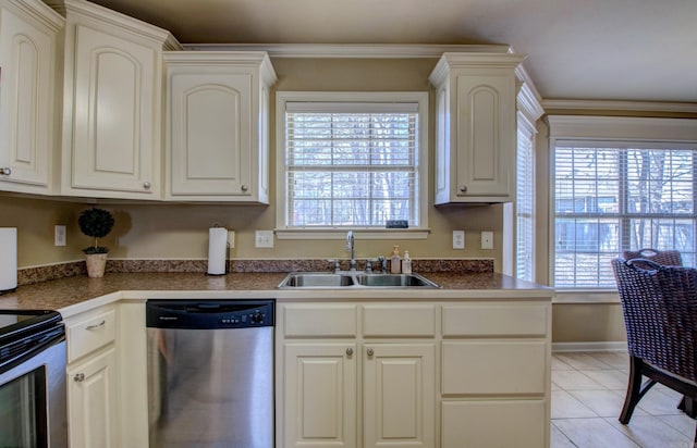 kitchen with light tile patterned floors, a healthy amount of sunlight, stainless steel appliances, and a sink