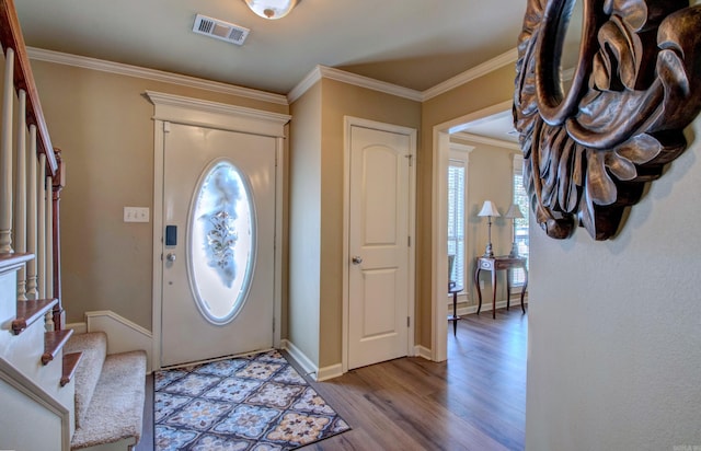 entryway featuring baseboards, visible vents, stairs, crown molding, and light wood-type flooring