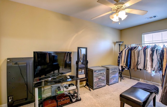 interior space with visible vents, carpet floors, baseboards, and a ceiling fan