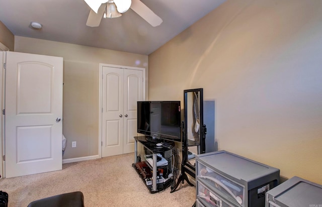 interior space with baseboards, ceiling fan, and carpet floors