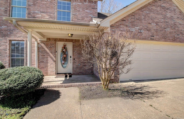 doorway to property with brick siding and an attached garage