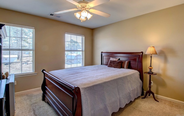 bedroom with visible vents, light carpet, and multiple windows