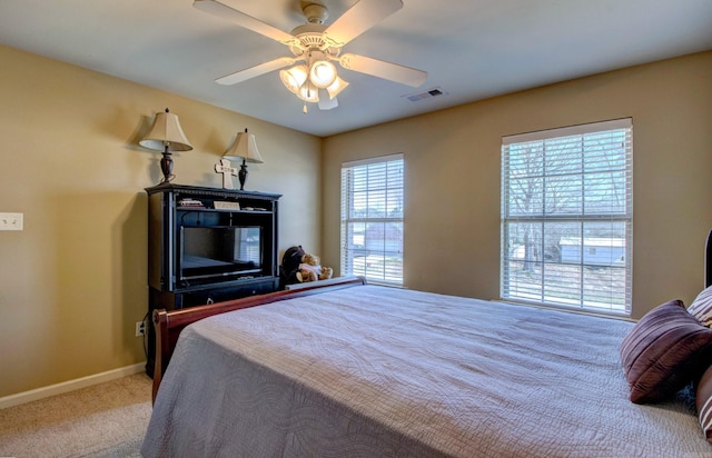 bedroom with visible vents, ceiling fan, baseboards, and carpet