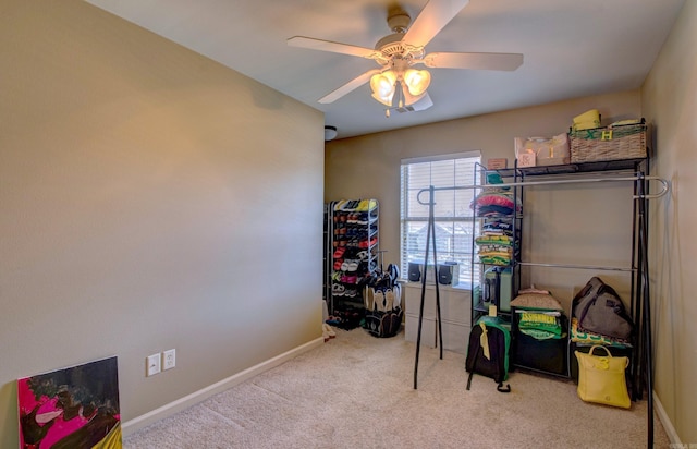 recreation room featuring carpet flooring, a ceiling fan, and baseboards