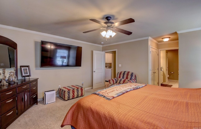 bedroom featuring ensuite bath, washer / dryer, ceiling fan, crown molding, and light colored carpet